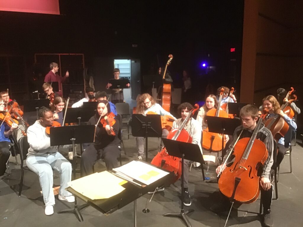 Darby combined symphonies rehearsing on stage