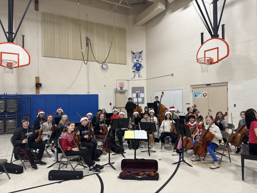 Tharp Orchestra Holiday Ensemble performing in the Norwich gymnasium