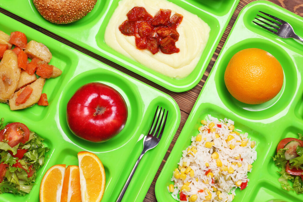 Serving trays with delicious food, closeup. Concept of school lunch