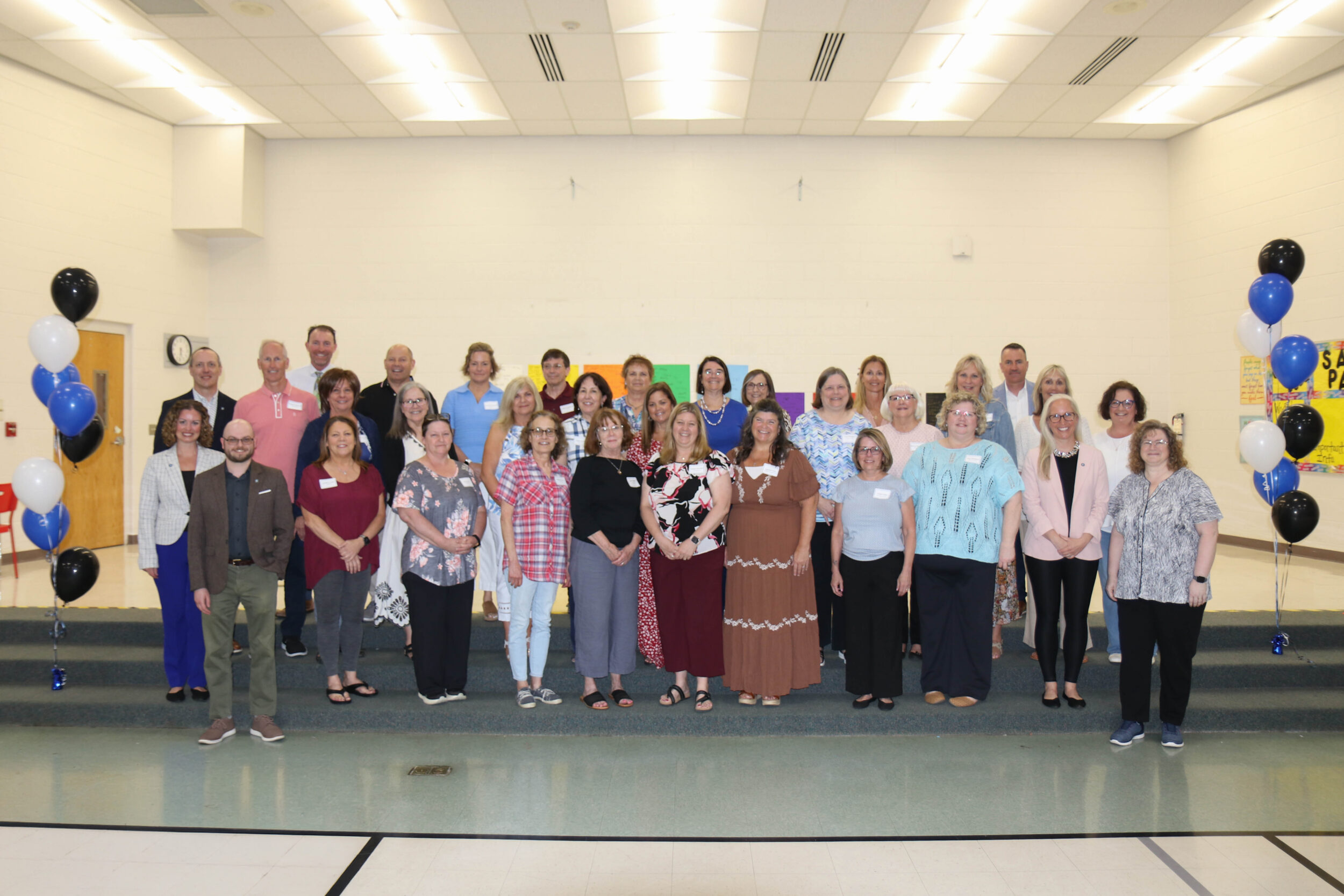 Group of people standing smiling for a picture