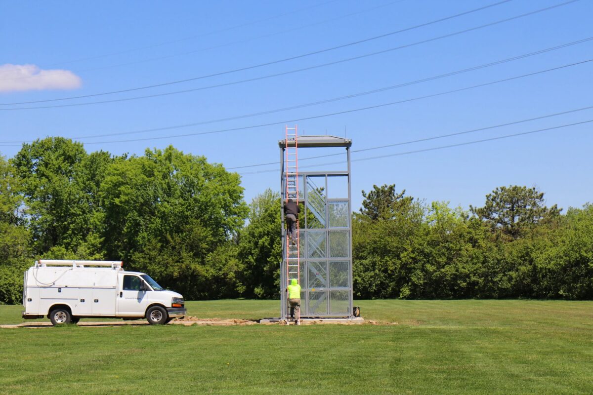 Band tower with school behind it