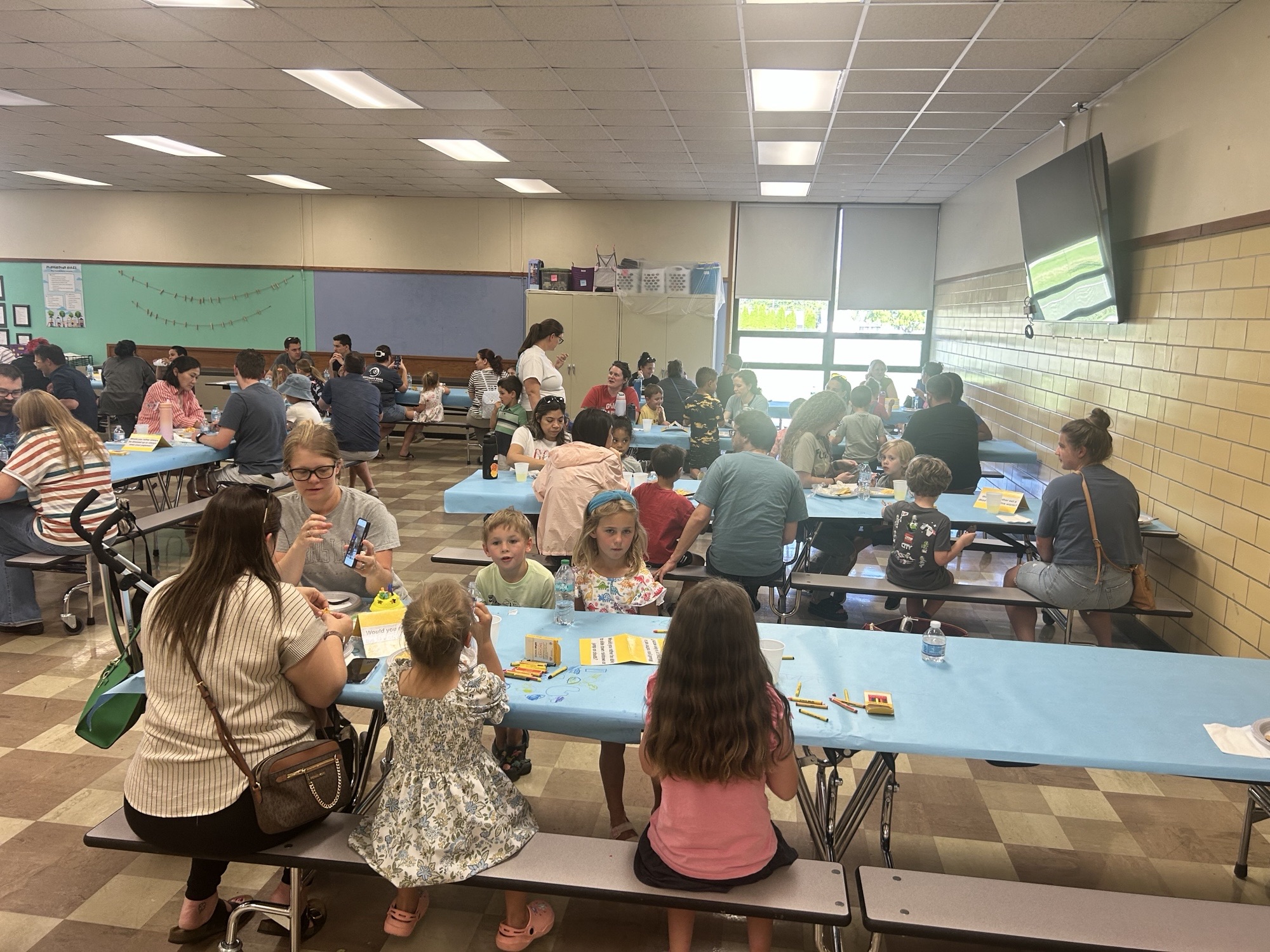 Kids and Parents sitting at tables and drawing