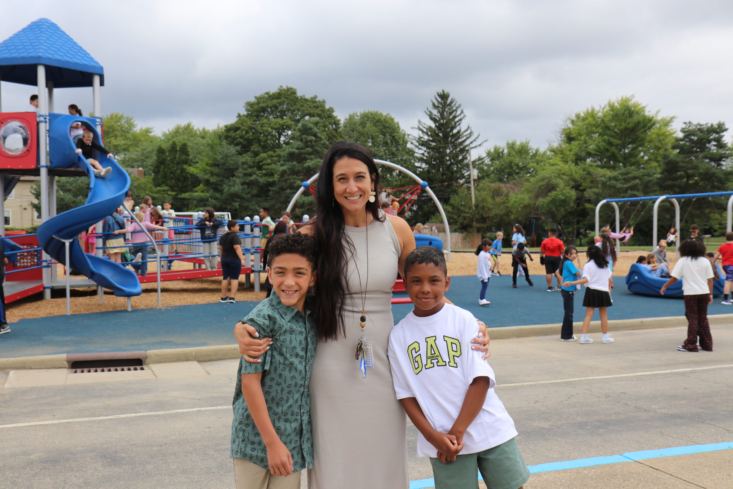Principal standing with students