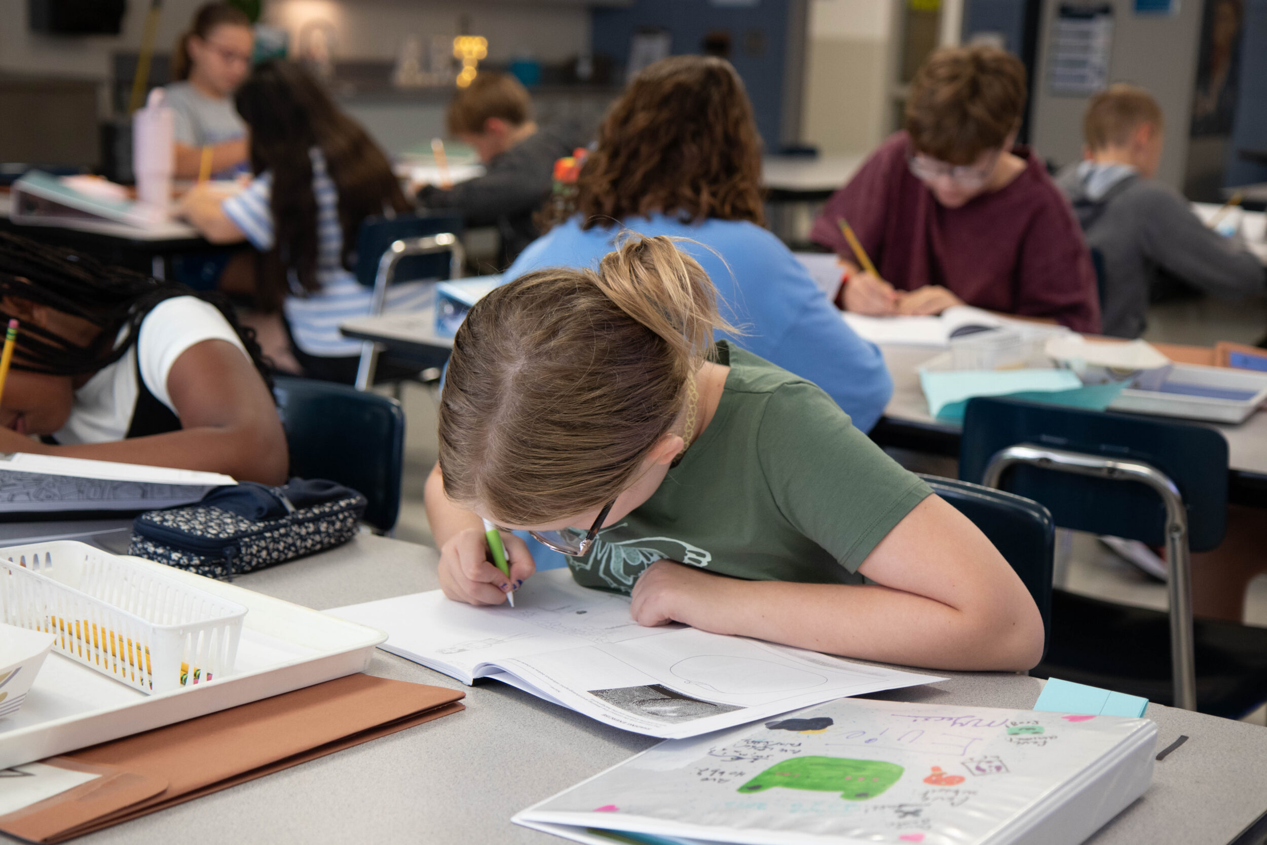 Student writing on paper