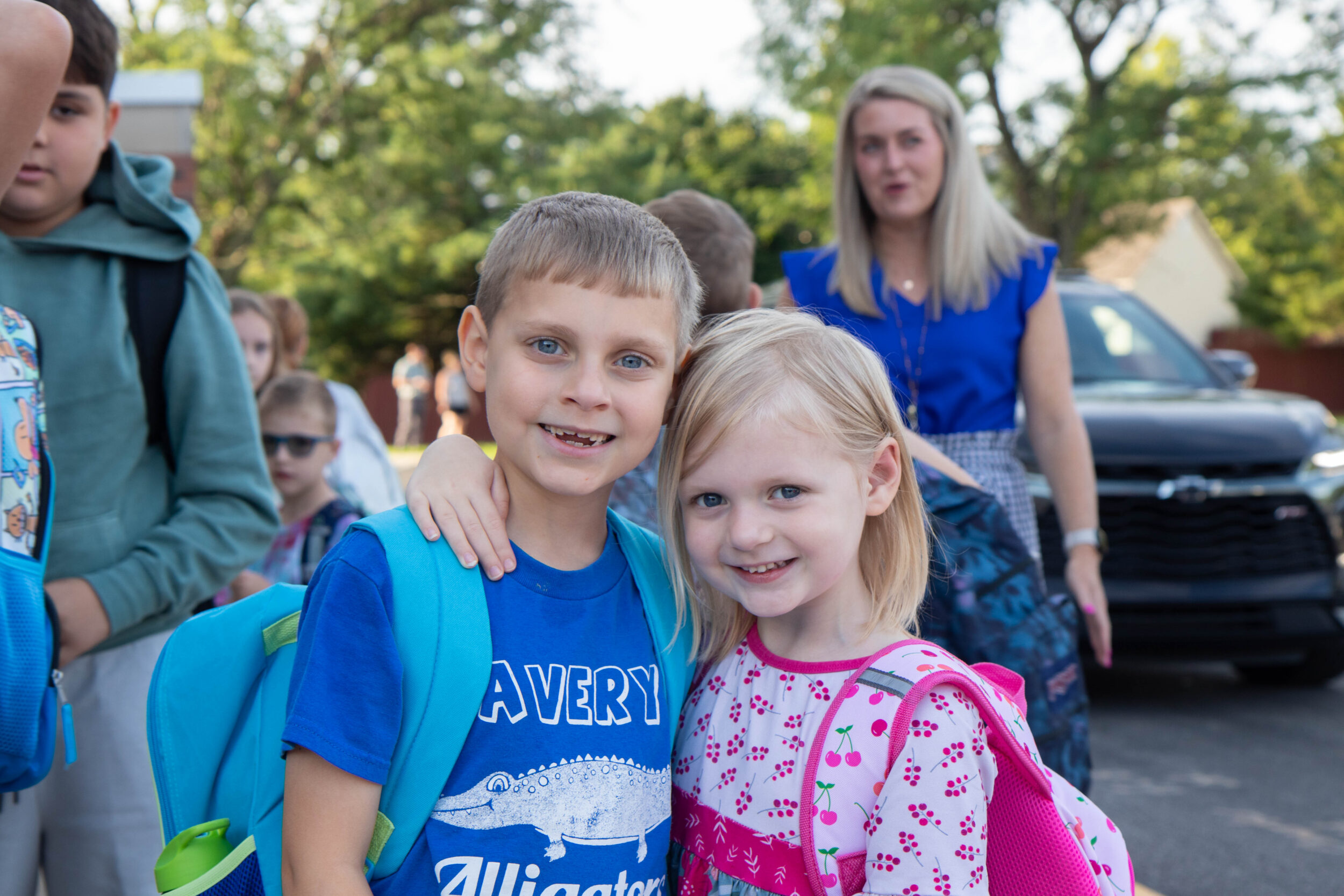 Two students smiling with backpacks on